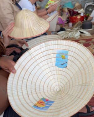 Nazanin Amiri Instagram - Workshop for making Vietnamese hats in one of the villages of Vietnam 🇻🇳(part 1 )location (Chuong hat village)
The process of making traditional Vietnamese conical hats (known as “Non La”) involves several steps:

1. **Material Collection**: Palm leaves or bamboo are used for the structure, and natural or synthetic thread for binding.

2. **Drying**: Leaves are dried to ensure they can be shaped and are durable.

3. **Base Preparation**: A bamboo or wooden ring forms the base of the hat.

4. **Weaving and Binding**: The dried leaves are woven around the base, often using thread to secure them.

5. **Shaping**: The hat is carefully shaped to ensure it fits properly and is symmetrical.

6. **Decoration**: Sometimes decorative elements like fabric or colored threads are added.

7. **Final Touches**: The hat is checked for quality, ensuring it’s both functional and visually appealing.

These hats are lightweight, protective, and a significant cultural symbol in Vietnam.
@nazaninamiri_official 
#vietnam #culture