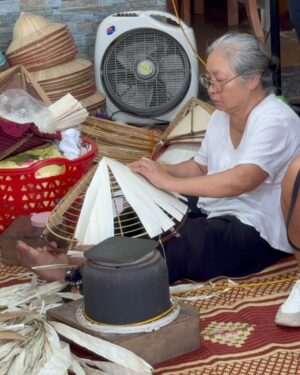 Nazanin Amiri Instagram - Workshop for making Vietnamese hats in one of the villages of Vietnam 🇻🇳(part 1 )location (Chuong hat village)
The process of making traditional Vietnamese conical hats (known as “Non La”) involves several steps:

1. **Material Collection**: Palm leaves or bamboo are used for the structure, and natural or synthetic thread for binding.

2. **Drying**: Leaves are dried to ensure they can be shaped and are durable.

3. **Base Preparation**: A bamboo or wooden ring forms the base of the hat.

4. **Weaving and Binding**: The dried leaves are woven around the base, often using thread to secure them.

5. **Shaping**: The hat is carefully shaped to ensure it fits properly and is symmetrical.

6. **Decoration**: Sometimes decorative elements like fabric or colored threads are added.

7. **Final Touches**: The hat is checked for quality, ensuring it’s both functional and visually appealing.

These hats are lightweight, protective, and a significant cultural symbol in Vietnam.
@nazaninamiri_official 
#vietnam #culture