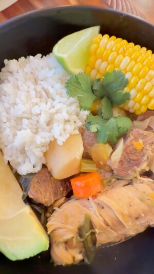Omallys Hopper Instagram - Hola Mi Gente! Is there anything better than a Sancocho on a cold day?? Receta Aquí ⬇️⬇️⬇️
* Meats:
 * 3 lbs chicken thighs (skinless)
 * 1.5 lbs beef (cut into chunks)
* Vegetables:
 * 2-3 stalks celery (chopped)
 * 2-3 carrots (sliced)
 * 1 large onion (chopped)
 * 4 cloves garlic (machacao’)
 * 1 bunch cilantro (chopped)
 * 1 bunch culantro (chopped)
 * 1 celery root (peeled and chopped)
 * 1 batata (Asian sweet potato, peeled and chopped)
 * 1 yautía blanca (white taro root, peeled and chopped)
 * 1 malanga (peeled and chopped)
* Other Ingredients:
 * 1 cup sofrito
 * 2-3 tbsp aceite de achiote (annatto oil)
 * 8 cups water or chicken broth
 * 1 tablespoon chicken bouillon paste 
 * Salt and pepper to taste
 * 2 ears of corn (cut into pieces, optional)
 * 2 green plantains (peeled and sliced, optional)
Instructions:
1. Season and Sauté the Meats:
 * In a large bowl, season the chicken thighs and beef with sofrito, aceite de achiote, salt, and pepper and garlic
 * Add the seasoned beef, and brown on all sides. Wait about 20 minutes and thrown in the seasoned chicken
2. Sauté the Aromatics:
 * In the same pot, add the onions, celery, carrots, and ajicitos. Sauté until fragrant and translucent. Cook for another 2-3 minutes.
3. Combine Ingredients:
 * Add the chopped celery root, batata, yautía blanca, malanga, and any optional vegetables.
 
4. Season and Simmer:
 * Add the chopped cilantro and culantro.
 * Season with chicken bouillon paste, additional salt and pepper to taste.
 * Bring the mixture to a boil, then reduce the heat to low and let it simmer for about 1.5 to 2 hours, or until the meats and vegetables are tender.
15 minutes before it’s done, add corn and green bananas or plantain
5. Final Touches:
 Enjoy with white rice, avocado and garnish with cilantro and lime wedge 😊🫶🏽