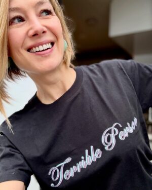 Rosamund Pike Instagram - Nothing shocks me. To celebrate a year since the release of Saltburn,  Emerald Fennell and Carey Mulligan have partnered with @warchilduk to design 8 limited edition “Saltburn Insults” t-shirts for their Emergency Christmas Appeal. 
 
In honour of the peerless fashion of the mid 2000s, these t-shirts have been lovingly crafted with Microsoft Word in a tasteful selection of license-free fonts: the perfect gift for your cold-blooded father, sexually incontinent daughter, or shit-stirring cousin. 
 
You can buy yours now on @everpresshq . The link is in my bio