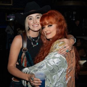 Wynonna Judd Instagram - Camera roll crumbs from 2024. Looking back with a grateful heart!!! 

1- Got to play in Alaska again 🩵
2- Married off the final Moser son 💍
3- The best group to be stuck in an airport with ✈️
4- Sparkles. Duh. ✨
5- Meet Moonshine! 🐮 Kaliyah loves giving him treats!
6- BTS 📸
7- @starletjudd is a really good sport 💕
8- Hazel Claire has already stolen my heart 🎀
9- We love Austin!!! 🎶
10- Ryman selfies with @ashleymcbryde 🤳
11- Farm life. 🐔
12- I 💚 @laineywilson
13- Girls night out @robertswesternworld 🥂
14- Spent time with @officialstetsonwright and his sweet family 🤠
15- Princess Kaliyah’s first time trick or treating! 🎃
16- Boomer.🥤
17- Nonie’s little sous chef. 👩🏼‍🍳
18- First time using my @kubotausa mower. 🚜
19- Cooking in stage clothes. What else is there to do? 🍅
20- No caption needed. 😆🏓