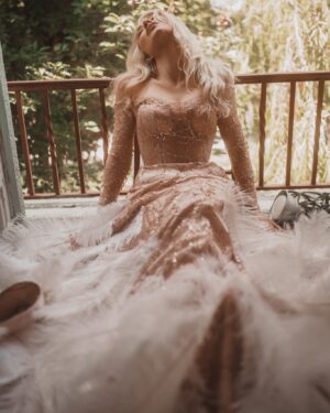 Alexandra Vino Instagram - Awaiting Summer…. Dripping in elegance by @annaguptaofficial wrapped in feathers, and lost in a dream ✨✨ Embracing the beauty of the moment, one step at a time. 📸 @theckm @aarongomezp styling…. #GoldenHourGlow#Elegance #LuxuryFashion #Glamour #DreamyVibes #GoldenHour #FeatherGown #HollywoodAesthetic #Graceful #TimelessBeauty #HighFashion