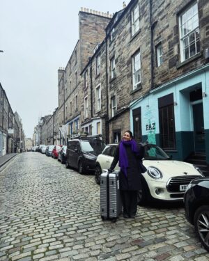 Amrita Puri Instagram - This photograph is from my last day in Edinburgh when I scheduled an impromptu ear piercing and had to make a dash to buy an extra large suitcase for all my stuff. I have zero concept of space and am only capable of last minute packing (big surprise)! Turns out that the ear piercing studio was on the very same cobbled street I had stayed in when I first came to Edinburgh. Life really does come full circle. 

Leaving Mumbai was more than a geographical move. It was a leap away from family and familiar chaos into Edinburgh’s quiet embrace. Cafés close at 4pm and the streets are empty by 9 pm —a world apart from my hometown’s perpetual energy. I remember I had texted a friend of mine when I felt really lonely and seriously questioned my decision to do my masters in Edinburgh. Was this move a big mistake? Trying to comfort me she had said: “Puri, when the time comes to leave Edinburgh, you’ll be crying because of the incredible memories you’ll have created.” She was right! 

What began with anxiety transformed into a journey of profound personal growth. “Do the things that scare you most”. There’s so much to gain from pushing yourself out of your comfort zone.This past year and a half has been one of the most amazing experiences of my life. I am returning to home with some seriously overstuffed suitcases 🧳 and a heart full of gratitude. You shall always be home for me 30 Howe street. 

P.S.- special thanks for helping me pack and all that non stop vaccum pumping @gaaaaayathriiiii 
I really couldn’t have done it without you. As well as @eloisea46 & @victoria.e.alvarado for the emotional and physical support. And just lots of love to all my friends.