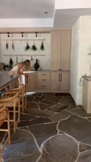 Lauren Liess Instagram - What walk-out basement dreams are made of ✨ A total dream creative space, our clients wanted a craft room / herb / potting area in their basement that walks out to the vegetable garden. They also entertain down here so we tricked the space out with hidden appliances like a drink fridge and dishwasher. To get more info about the German schmear stone walls, check out some of my earlier reels about this basement. The floors are (heated) flagstone, the island countertop is zinc, and the cabinets are from @uniquekitchensandbaths 🤍 Design by us @laurenliessandco   renovation by @carrmichaelconstruction