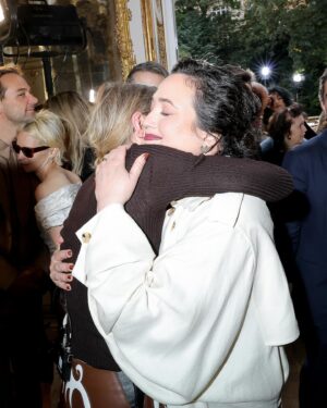 Lily Gladstone Instagram - Our dear friend @lilygladstone attending our Spring Summer 2025 show in Paris.
Lily wears an ivory textured linen slub Casper trench coat with watteau-back detail and ivory cashmere Knite knit dress from the Spring Summer 2025 paired with the cognac nappa leather Bocca boot and the chocolate nappa leather medium Leonora flap bag