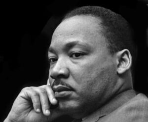 Rhiannon Giddens Instagram - These are excerpts from a very different dream speech from MLK, Jr. He says a lot here, July 4, 1965.

(10:15):
…that through our scientific genius, we have made of this world a neighborhood. Now, through our moral and ethical commitment, we must make of it a brotherhood, and we must all learn to live together as brothers [and sisters] or we will all perish together as fools. Every individual must learn this and every nation must learn this. Every nation must realize its dependence on other nations.

(13:13):
All I'm saying is simply this, that all life is interrelated. We are tied in an inescapable network of mutuality, tied in a single garment of destiny. Whatever affects one directly, it affects all indirectly. As long as there is extreme poverty in this world, no one can be totally rich even if he has a billion dollars. As long as diseases are rampant, and millions of people cannot expect to live more than 28 or 30 years, no one can be totally healthy even if he just got a checkup in the finest clinic of the nation.

(22:12):
Now we must get rid of two false ideas in order to continue to engage in creative protests. One idea is the myth of time. There are those people who argue that time alone will solve this problem. So, they say you must not push things. You must be patient. You must sit down and wait. And sometimes they decorate it in even larger terms. They say cool off for a while, slow up for a while. Time is the only thing that can solve this problem. What we must come to see is that evolution is true in the biological realm. So, Darwin is right at that point.

(23:01):
But when Herbert Spencer seeks to apply it to the whole of society there is little evidence for it. Human progress never rolls in on the wheels of inevitability. It comes through the tireless efforts and the persistent work of dedicated individuals. And without this hard work, time itself becomes the ally of the insurgent and primitive forces of irrational emotionalism and social stagnation, so that we must somehow get rid of this idea that time alone with solve the problem. We must use time.

The whole speech has so much in it. Link in bio.

PS - his expression is exactly how I feel.