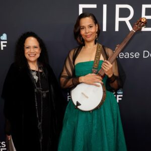 Rhiannon Giddens Instagram - I will be posting black history/excellence posts again for sure. Just wanted to report back on my little corner of the GRAMMYs, which happened yesterday.  I was nominated for Best American Roots Performance, for the recording of “The Ballad of Sally Anne”, a heartbreaking song about a lynching, which I recorded in Ireland with Francesco Turrisi and Ben Rawlins, and was finished by Ebonie Smith, for Fiona Prine’s Oh Boy Records. It was written by Alice Randall, who has been working in Nashville for over 40 years, writing anthems for black women while there weren’t many of us allowed into the establishment to sing them.  That was our win; the trophy itself went to someone else and that’s fine by me! There’s room for us all.

I took Alice as my date and we had a ball dropping nuggets of knowledge all down the red carpet, with my banjo in tow 🙂 (yes the 1858-replica banjo that graced the album of the year with its deep funky sounds... ) 

For me, being involved in this deeply cultural music is more than a career, it’s more than an album, it’s more than a single.  It’s a mission to show how beautiful Americans can actually be together; it’s proof that we are more alike than we are different, and it’s a study in how we do not need a hyphen; if anything, American history itself needs a hyphen.  We are America; America is us.  And the groundwork that the folks before us laid, like Linda Martell yes, but also Lil Hardin, and Libba Cotten, and Joe Thompson, and Ray Charles; and folks laying all the groundwork right NOW, like Rissi Palmer, and Dena Ross Jennings, and Angela Wellman, and so many others, educating and welcoming and doing all the active things you do to build real community.  It takes time; it takes humility; it takes interest in other people and other people’s success.

For me, saying their names, all of them, makes me feel grounded.  For me, acknowledging that I would not be here without them, makes me feel stronger.  The rising tide lifts all boats.