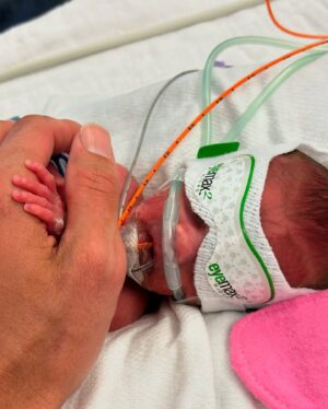 Sara Dietschy Instagram - I could write a caption as long as a book describing what happened the night you were born. The brutal week leading up to that day. The 2 months in the NICU. The moments of despair sitting in bed alone pumping without you in my tummy but also without you next to me. I had no idea what to expect. 

However — I’m making a conscious effort to leave a lot of the weight in 2024. The word we keep coming back to is GRATEFUL. Phewww. Grateful for your giggles. Grateful for your already amazing personality. Grateful for the snuggles we get every single day. Grateful for your daddy and our amazing supportive family that has always been there for us. Grateful for my amazing therapist! and also grateful for you guys online for always having kind words. Grateful for 1️⃣🎉🎂🥳🎈

Happy birthday baby girl. 

It is insaneeeee seeing NICU pictures of you now. In awe of your strength. I think we would have all preferred your original due date in April for MANY reasons but it was pretty cool to get snow on your bday🧡 A 27 2 QUEEENNNNN 💪