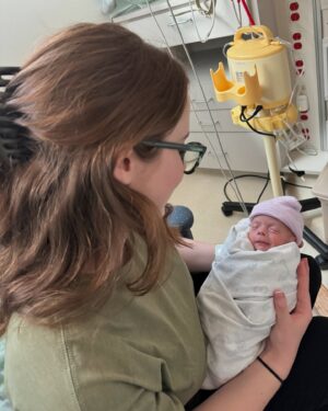 Sara Dietschy Instagram - I could write a caption as long as a book describing what happened the night you were born. The brutal week leading up to that day. The 2 months in the NICU. The moments of despair sitting in bed alone pumping without you in my tummy but also without you next to me. I had no idea what to expect. 

However — I’m making a conscious effort to leave a lot of the weight in 2024. The word we keep coming back to is GRATEFUL. Phewww. Grateful for your giggles. Grateful for your already amazing personality. Grateful for the snuggles we get every single day. Grateful for your daddy and our amazing supportive family that has always been there for us. Grateful for my amazing therapist! and also grateful for you guys online for always having kind words. Grateful for 1️⃣🎉🎂🥳🎈

Happy birthday baby girl. 

It is insaneeeee seeing NICU pictures of you now. In awe of your strength. I think we would have all preferred your original due date in April for MANY reasons but it was pretty cool to get snow on your bday🧡 A 27 2 QUEEENNNNN 💪