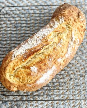Silvia Colloca Instagram - Súper quick and incredibly delicious bread, if you feel like baking, but don’t have time to prove dough overnight. Xxx

Yogurt and olive oil filone (loaf)

500 gr all purpose or 00 flour
200 gr unsweetened Greek yogurt
200 ml water
7 gr of dry yeast 
1-1/2 tablespoon sea salt
2 tablespoons olive oil 
 Place flour, water, dry yeast oil and yogurt in a large bowl. Mix until just combined then add salt and mix through. Cover with a damp tea towel and let it rise at room temperature for 1 hour. The dough will look puffier and more relaxed, stretch it a little with wet hands (still in the bowl, no mess) and fold it onto itself in a bowl. Cover and repeat the stretching and folding one more time after 30 minutes. Cover again and allow to prove completely until more than doubled in size (about 45 minutes). Flour your bench and hands and stretch the dough into a rectangle, it will feel a little soft, then roll it up like a big cigar. Place on a baking tray lined with baking paper, flour the top and prove for 30 minutes. In that time bring your oven to 220 C and place an empty metal bowl or empty oven tray on the lower rack. 
The dough will now look puffy. Dust more flour on top, score and place in the oven, on the middle rack. Pour in some water on the lower oven tray or metal bowl you’ve been preheating to create steam. Close door and bake for 35-40 minutes or until golden and cooked through. Cool on a rack for at least 30 minutes before serving as the crumb keeps baking and settling in the cooling time. 
🥖❤️
Enjoy!