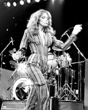 Carly Simon Instagram - I am exiting the stage ahead of James after we sang Mockingbird at the NoNukes concert in September, 1979. The jumpsuit was made by Marcia Trinder, who was also known for making stage outfits for Mick Jagger. 

I remember going to the dressing room to slip into something a little more comfortable, only to realize I had to get back into the tight striped jumpsuit and on stage for Dylan's song, "The Times They Are A-Changin'" with James, John Hall, and Graham Nash. 

📸: Peter Simon
#CarlySimon #MarciaTrinder #MickJagger