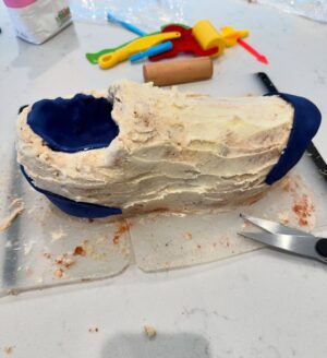 Charlotte Hawkins Instagram - The grand reveal of my trainer cake! As my husband Mark is running the London Marathon for @mndassoc I wanted to do my bit for a fundraising event... and had a bit of a marathon cake-making session inspired by one of his trainers! 👟 I watched a lot of YouTube videos in preparation, having never done this before - but to be honest I’m not sure I’d recommend undertaking it unless you have a spare 12 hours or so 🤣 but here is my method just in case! Not quite ‘Is it Cake’ level but at least it tasted good!! 
I put this on my stories as I was creating it - a big thanks for all the support, it got me through it!! 
• the inspiration
• an awful lot of cake mix
• 4 cakes and the templates - ended up needing 6 cakes!
• Sooo much buttercream….
• Bit of a pit-stop along the way 🤣 
• taking shape but it looks more like a clog at this stage!
• Sticking it all together with jam and buttercream, not the prettiest but it does the job
• Resorting to raiding Ella-Rose’s play-doh box for some modelling tools - a bit of a wash and they worked a treat! 😂
• an awful lot of fondant needed 
• starting the process of sticking it on
• the professionals have what’s called a ‘texture mat’ - I have a cheese grater… 
• templating the tricky sections
• shaping it into the finished article - don’t forget to thread those laces!!
Good luck if you try it 😂 
#cake #isitcake #cakemodelling #cakecraft #mnd #mndassociation #fundraising #londonmarathon