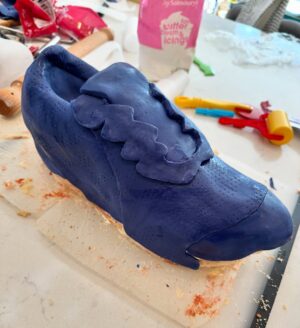 Charlotte Hawkins Instagram - The grand reveal of my trainer cake! As my husband Mark is running the London Marathon for @mndassoc I wanted to do my bit for a fundraising event... and had a bit of a marathon cake-making session inspired by one of his trainers! 👟 I watched a lot of YouTube videos in preparation, having never done this before - but to be honest I’m not sure I’d recommend undertaking it unless you have a spare 12 hours or so 🤣 but here is my method just in case! Not quite ‘Is it Cake’ level but at least it tasted good!! 
I put this on my stories as I was creating it - a big thanks for all the support, it got me through it!! 
• the inspiration
• an awful lot of cake mix
• 4 cakes and the templates - ended up needing 6 cakes!
• Sooo much buttercream….
• Bit of a pit-stop along the way 🤣 
• taking shape but it looks more like a clog at this stage!
• Sticking it all together with jam and buttercream, not the prettiest but it does the job
• Resorting to raiding Ella-Rose’s play-doh box for some modelling tools - a bit of a wash and they worked a treat! 😂
• an awful lot of fondant needed 
• starting the process of sticking it on
• the professionals have what’s called a ‘texture mat’ - I have a cheese grater… 
• templating the tricky sections
• shaping it into the finished article - don’t forget to thread those laces!!
Good luck if you try it 😂 
#cake #isitcake #cakemodelling #cakecraft #mnd #mndassociation #fundraising #londonmarathon