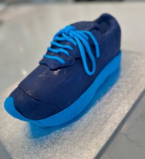 Charlotte Hawkins Instagram - The grand reveal of my trainer cake! As my husband Mark is running the London Marathon for @mndassoc I wanted to do my bit for a fundraising event... and had a bit of a marathon cake-making session inspired by one of his trainers! 👟 I watched a lot of YouTube videos in preparation, having never done this before - but to be honest I’m not sure I’d recommend undertaking it unless you have a spare 12 hours or so 🤣 but here is my method just in case! Not quite ‘Is it Cake’ level but at least it tasted good!! 
I put this on my stories as I was creating it - a big thanks for all the support, it got me through it!! 
• the inspiration
• an awful lot of cake mix
• 4 cakes and the templates - ended up needing 6 cakes!
• Sooo much buttercream….
• Bit of a pit-stop along the way 🤣 
• taking shape but it looks more like a clog at this stage!
• Sticking it all together with jam and buttercream, not the prettiest but it does the job
• Resorting to raiding Ella-Rose’s play-doh box for some modelling tools - a bit of a wash and they worked a treat! 😂
• an awful lot of fondant needed 
• starting the process of sticking it on
• the professionals have what’s called a ‘texture mat’ - I have a cheese grater… 
• templating the tricky sections
• shaping it into the finished article - don’t forget to thread those laces!!
Good luck if you try it 😂 
#cake #isitcake #cakemodelling #cakecraft #mnd #mndassociation #fundraising #londonmarathon