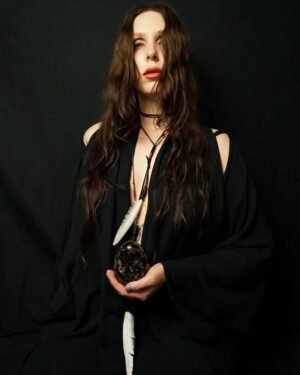 Chelsea Wolfe Instagram - Happy one year to She Reaches Out to She Reaches Out to She. 🕯️ 

The life cycle of an album is a wild thing - a birth and rebirth in its own right. I’m so thankful to everyone who worked to bring these songs to life, in so many ways. 🖤 

We’re still giving these songs new life, playing Cruel World on May 17 in Los Angeles, then touring Australia & Aotearoa May 21-May 30. Head to chelseawolfe.com/shows (link in bio) to check out the dates. 

This photo is a self-portrait from the night I started to conceptualize the visual direction for the album, inspired by Marjorie Cameron’s painting Black Egg. 

Thank you so much to everyone who has supported She Reaches Out. It means the world that it’s resonated with you.