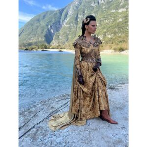 Madeleine Madden Instagram - Had to do a special post for the magnificent Amyrlin’s Armor and the incredible vision of @davinajl and @sharon_gilham_costume_design 

Egwene is a character who takes pride in her identity and her roots, and this costume honors that beautifully. From the intricate symbols of the Flame of Tar Valon to the reimagined Two Rivers braid, every element reflects who she is at her core. 
This look is quintessentially Egwene, a homage to her journey, her power, and the traditions that shaped her.
