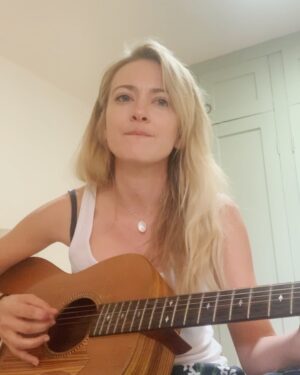 Meredith Hagner Instagram - im gonna share more of my folk songs i write because i love to do it dammit and also been doing it in secret for 15 years like someone sneaking cigarettes in an airport bathroom.  Gonna unpack why this is someday.Also these photos feel authentic to me. No more risky spray tans lots more street dogs.Hi.