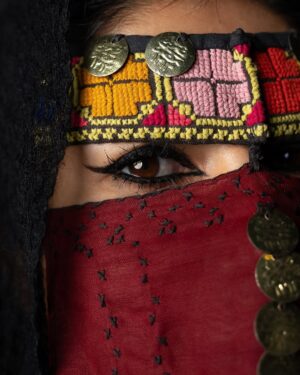 Zhalay Sarhadi Instagram - Palestinian Thobe 🍉

Amani Geha wears a 65-year-old traditional widow’s thobe from Beersheba, passed down through generations as a family heirloom. Rich in history, this handmade garment reflects the Bedouin style of the region, showcasing vibrant motifs and intricate embroidery that are more than just beautiful—they are storytellers. Each stitch carries deep meaning, with symbols like the geometric designs signifying fertility.

Palestinian thobes have long marked social status and identity. Each region has its own unique patterns. These garments, carefully crafted by hand over months, were made for life’s major events—weddings, mourning, and daily wear.

Today, the thobe is a symbol of cultural resistance and pride, worn at protests and global events to assert Palestinian identity. This photograph celebrates that resilience and the vital role of preserving these timeless traditions for future generations.

تَرتدي أماني جحا ثوبًا فلسطينياً تقليديًا من مدينة بئر السبع عمره فوق ال 65 عامًا، وقد تم توريثه عبر الأجيال كإرث عائلي. هذا الثوب اليدوي غني بالتاريخ ويعكس أسلوب البدو في المنطقة، حيث تظهر الزخارف النابضة بالحياة والتطريز الدقيق الذي ليس فقط جميلاً، بل يروي قصصًا. كل غرزة تحمل معنى عميقًا، فمثلاً ترمز التصاميم الهندسية الخصوبة. لطالما كان الثوب الفلسطيني علامة على المكانة الاجتماعية والهوية. ولكل منطقة في فلسطين أنماطها الفريدة. هذه الأثواب، التي يتم صنعها بعناية يدويًا على مدار شهور، صُنعت لتناسب المناسبات المهمة في الحياة، مثل حفلات الزفاف، والحداد، واللباس اليومي.

اليوم، يمثل الثوب رمزًا للمقاومة الثقافية والفخر، حيث يُرتدى في المظاهرات والمناسبات العالمية للتأكيد على الهوية الفلسطينية. تحتفي هذه الصورة بتلك القوة والصمود، والدور الهام في الحفاظ على هذه التقاليد الخالدة للأجيال القادمة.

Project credit:
Lead cast: @amaniegeha 
Director, Writer, Producer, DOP, Gaffer, Editor, Sound, Colorist: @moamenghanim 
Thoub generously provided by @feda_allouh 
Stylist: @ayatallax 
Makeup artist: @makeupbymaab 
Production assistant, BTS videographer: @janaislam___ 
1st AD, BTS videographer: @murielletannous 
Special thanks for @tasweer.qa @dohafirestation @almayassabnthamad @qatar_museums for facilitating the filming location
Source: @aljazeera