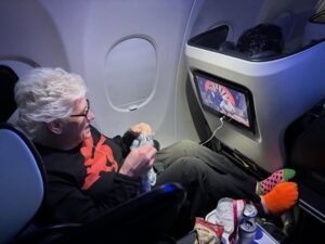 Anne Burrell Instagram - Ok… so this is a first… watching myself last night on #houseofknives while on a flight to Vegas!!! I was eating airplane snacks, knitting and watching like a crazy lady!! I think I look pretty good up there on the throne!!! Thank you to Nikol the lovely flight attendant who took the photo. 😊#ilovewhatido #luckygirl